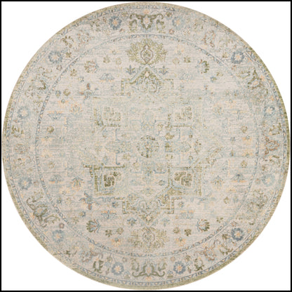Round area rug with a faded antique medallion motif in cream, pale blue and gray.