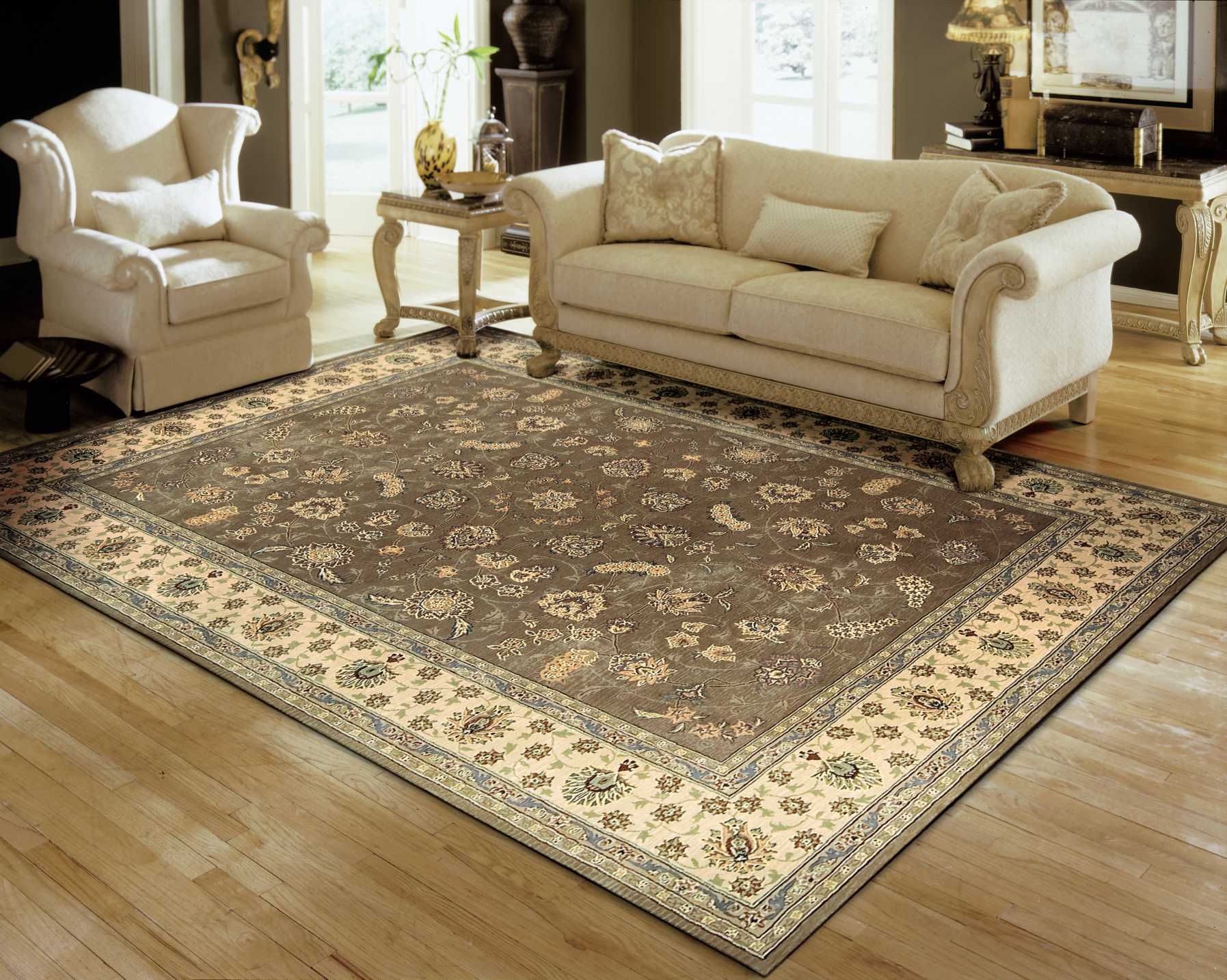 Large traditional oriental area rug with a brown field, cream border, and blue floral motifs in a beige living room.