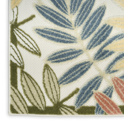 Close-up of botanical leaf print on textured woven fabric with blue, olive green and pink leaves on ivory background.