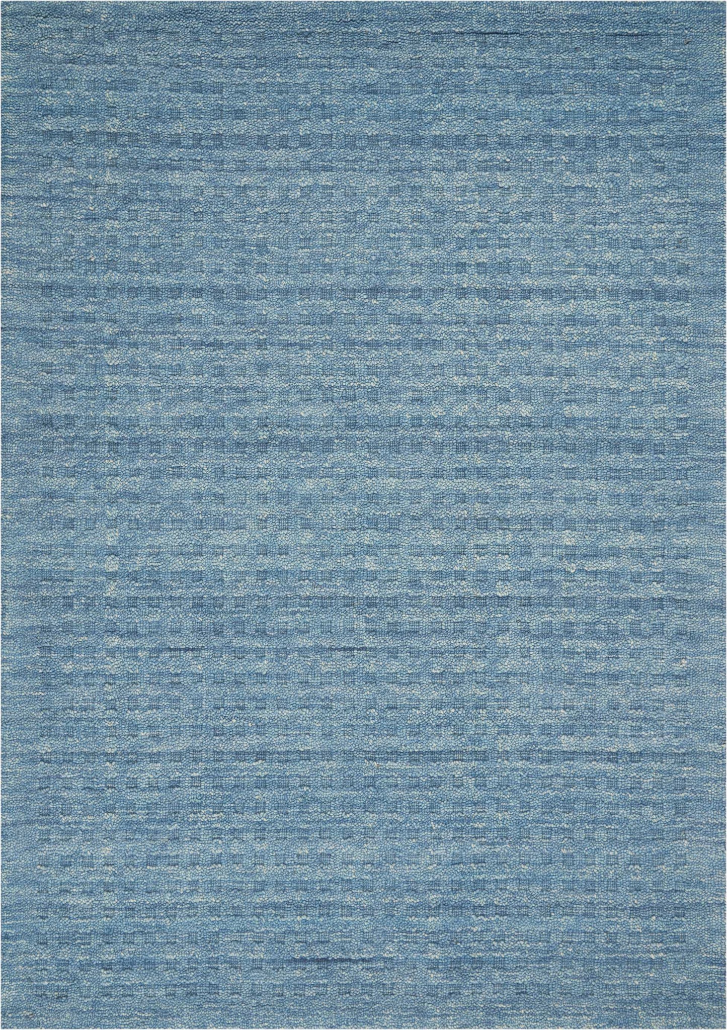 Blue woven rug with subtle, variegated blue tones and distressed texture; rectangular, ideal for living room decor.