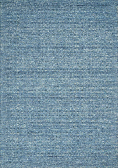 Blue woven rug with subtle, variegated blue tones and distressed texture; rectangular, ideal for living room decor.