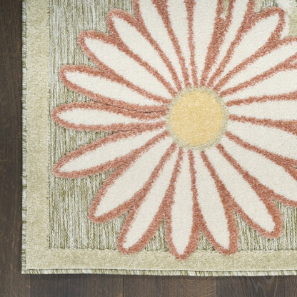 Rectangular rug featuring a large daisy: cream petals with pink edges, yellow center, beige border, textured green backdrop.
