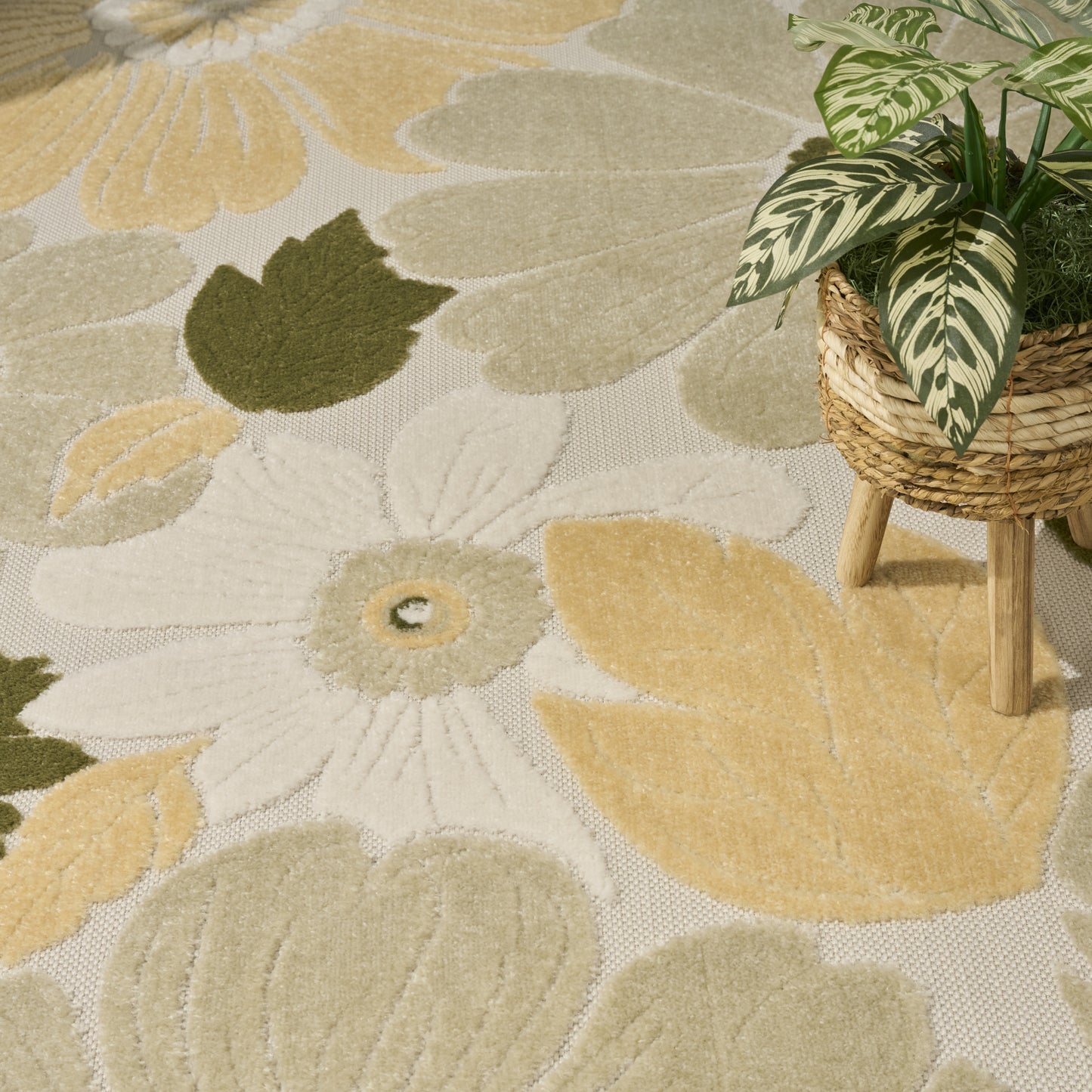 Floral patterned area rug in warm beige, ivory, pale yellow and olive green; soft woven texture for living room decor.