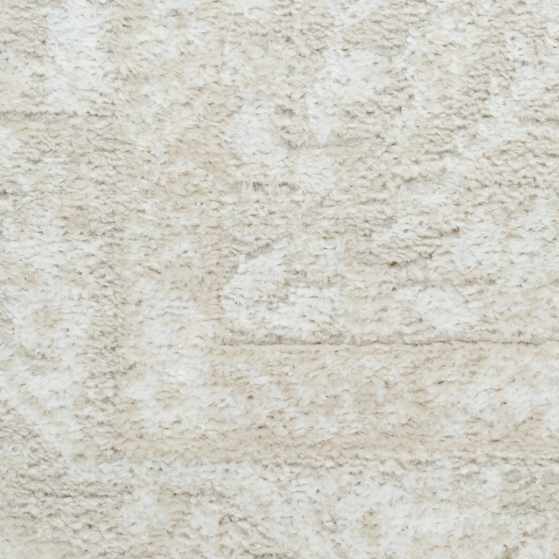 Cream shag rug with plush beige pile and subtle pattern for cozy living room flooring.