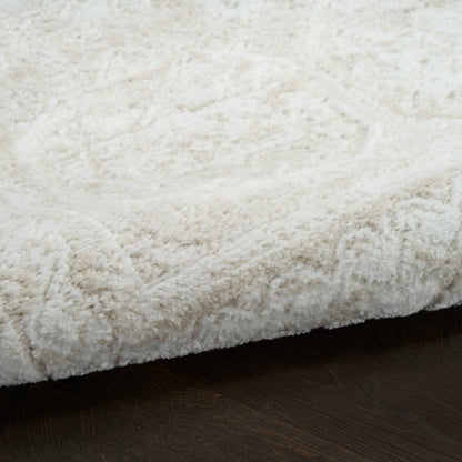 Cream fluffy shag rug with thick pile on dark wooden floor.