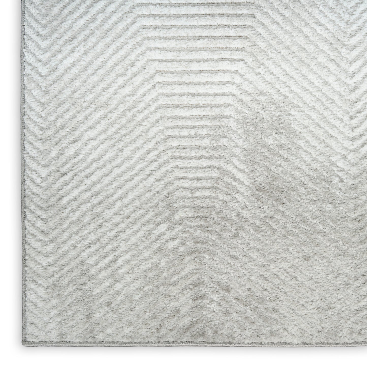 Light gray shag rug with a subtle chevron pattern and plush pile, vintage rectangular area rug.