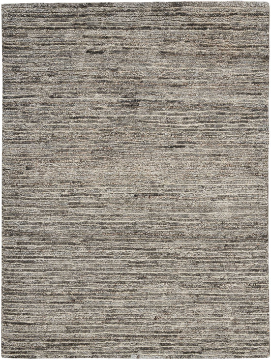 Grey, taupe and beige striped area rug with textured, layered lines and low pile.