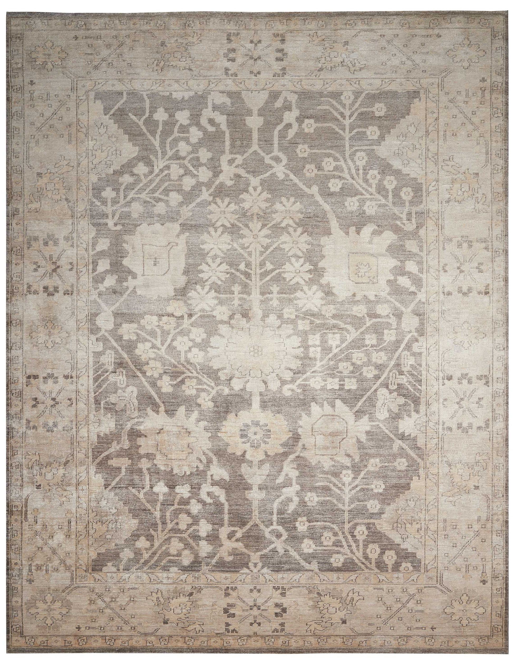 Rectangular vintage-style area rug in beige and gray with a distressed floral medallion pattern and ornate border.