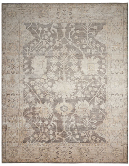 Rectangular vintage-style area rug in beige and gray with a distressed floral medallion pattern and ornate border.