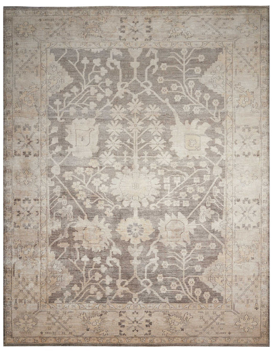 Rectangular vintage-style area rug in beige and gray with a distressed floral medallion pattern and ornate border.