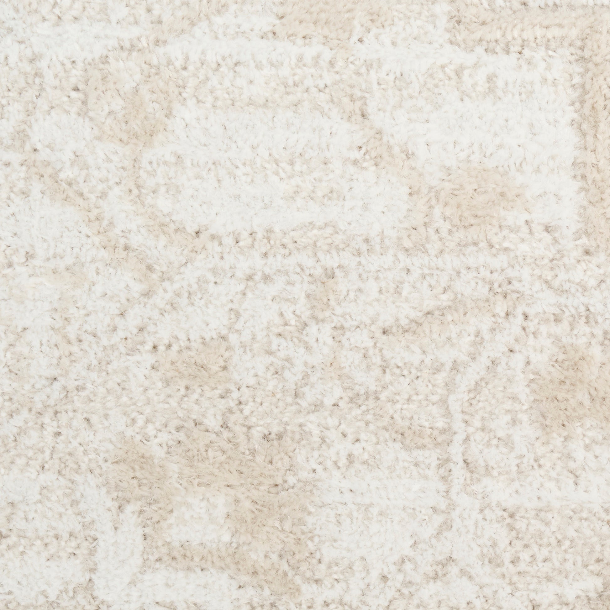 Cream shag rug with plush, high-pile texture and subtle abstract beige pattern.
