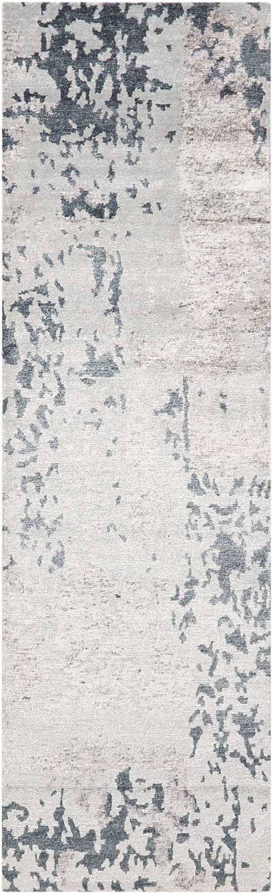 Rectangular area rug with abstract gray-blue splotches on creamy beige base; distressed modern pattern.