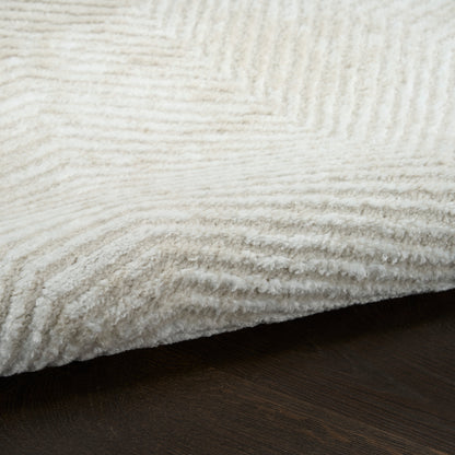 Cream shag rug with dense, plush pile on dark wood floor.