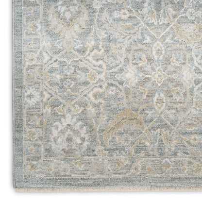 Soft blue and ivory distressed oriental rug with floral motifs and light border; fringed edges, ideal for living rooms.