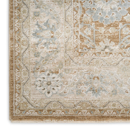 Rectangular distressed antique-style area rug in pale blues, beiges and taupes with floral border and soft fringe.