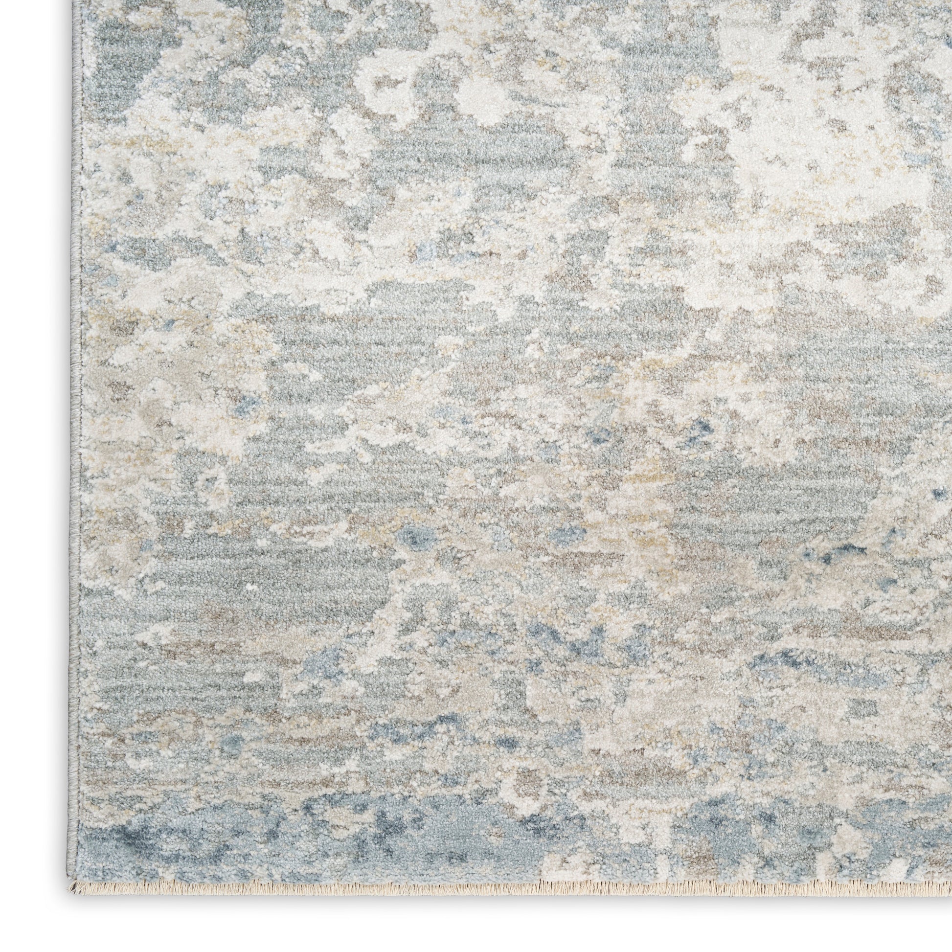 Muted blue, beige & ivory abstract area rug with cloud-like pattern and soft texture.