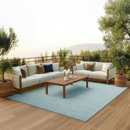 8x10 aqua blue indoor outdoor area rug from the Positano collection by Nourison featuring a modern solid design with subtle woven texture. Durable polypropylene machine-made rug designed for patios, decks, porches, living rooms, bedrooms, and dining rooms. Lightweight, stain-resistant, and easy-clean rug ideal for high-traffic areas and homes with pets or kids. Modern coastal rug perfect for contemporary, minimalist, and boho home decor.