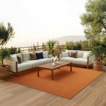 Nourison Positano 8x10 terracotta indoor outdoor area rug, modern flatweave polypropylene rug in warm rust terracotta color, durable low pile patio rug for deck balcony living room dining room, contemporary textured solid color rug for boho Mediterranean coastal and modern home decor.