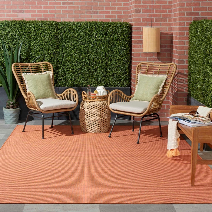 zNourison Positano 8x10 terracotta indoor outdoor area rug, modern flatweave polypropylene rug in warm Orange / terracotta color, durable low pile patio rug for deck balcony living room dining room, contemporary textured solid color rug for boho Mediterranean coastal and modern home decor.