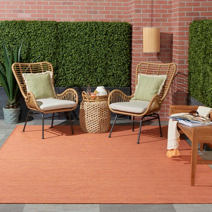 zNourison Positano 8x10 terracotta indoor outdoor area rug, modern flatweave polypropylene rug in warm Orange / terracotta color, durable low pile patio rug for deck balcony living room dining room, contemporary textured solid color rug for boho Mediterranean coastal and modern home decor.