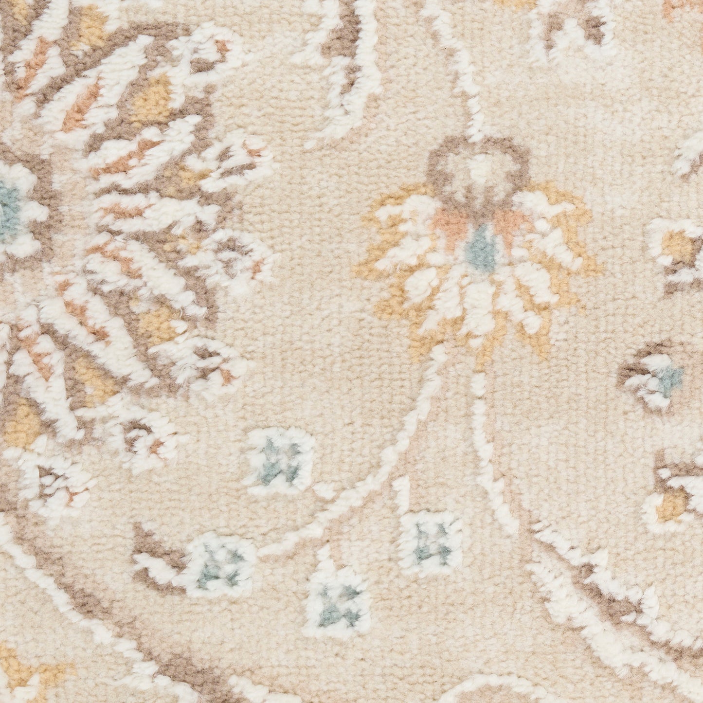 Cream-beige rug with delicate blue and yellow floral vine pattern and soft plush pile.