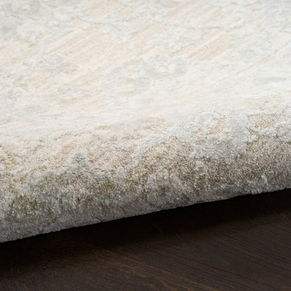 Beige and ivory damask patterned rug, low pile, rolled edge resting on dark wood floor.
