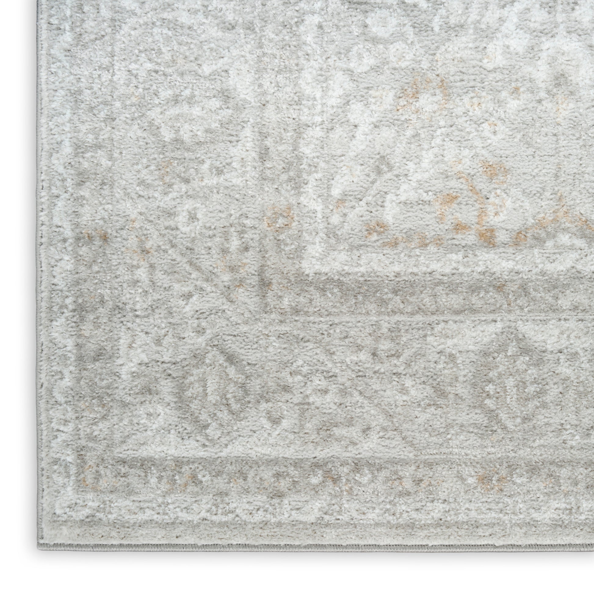Light gray distressed oriental rug with subtle ivory floral pattern, decorative border and plush pile.