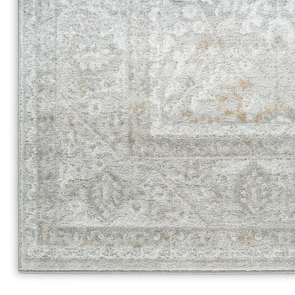 Light gray distressed oriental rug with subtle ivory floral pattern, decorative border and plush pile.