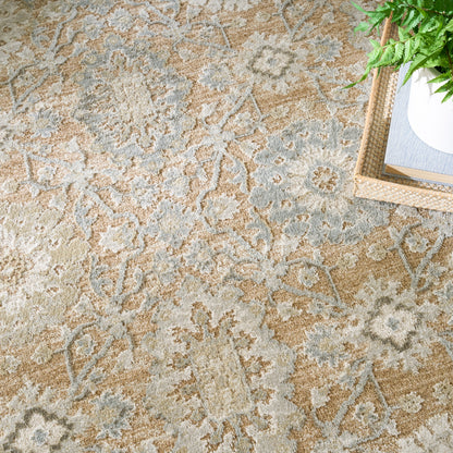 Beige & gray ornate patterned rug with floral medallions; wooden tray with a plant in the corner.