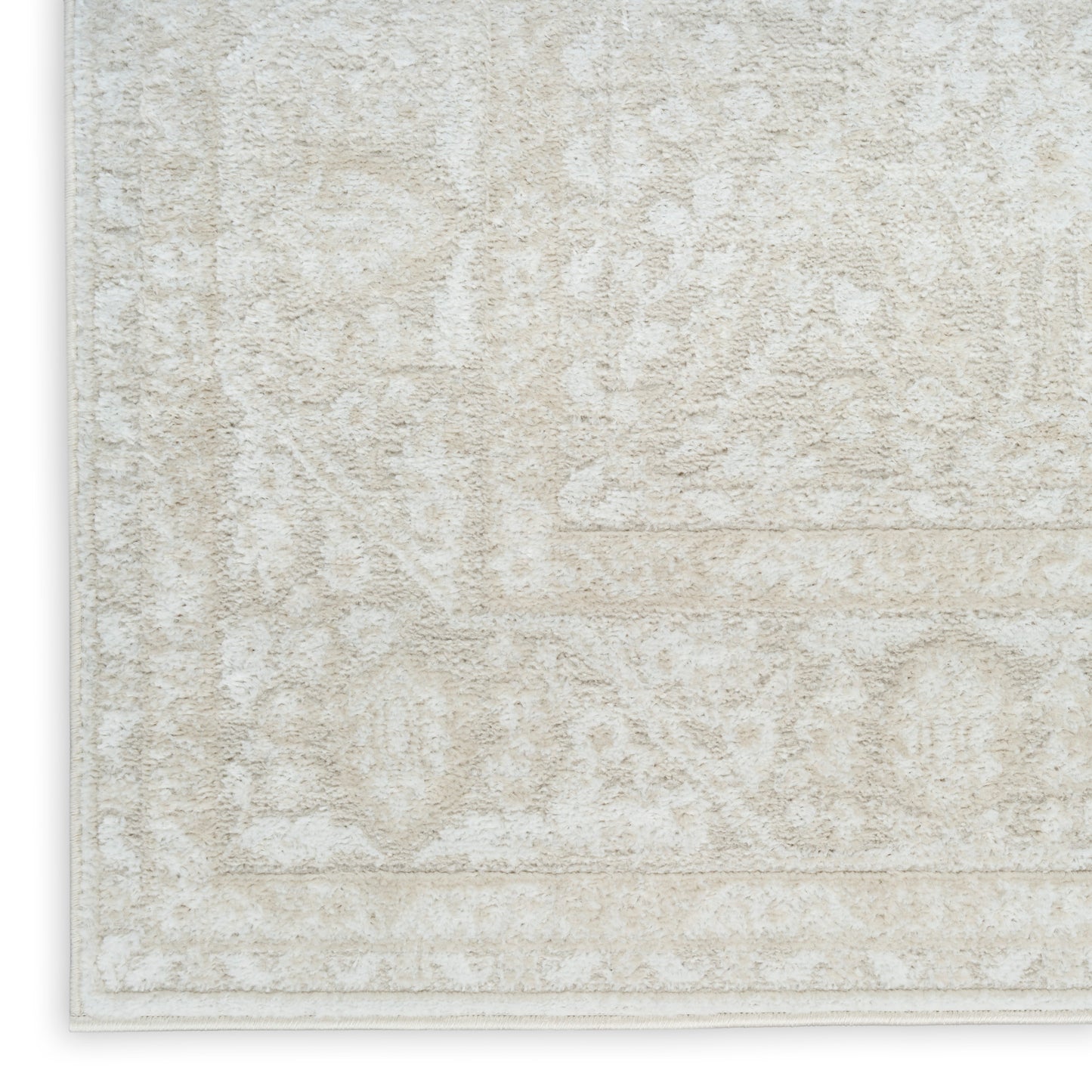 Cream beige oriental-pattern area rug with ivory motifs and light border, plush texture.
