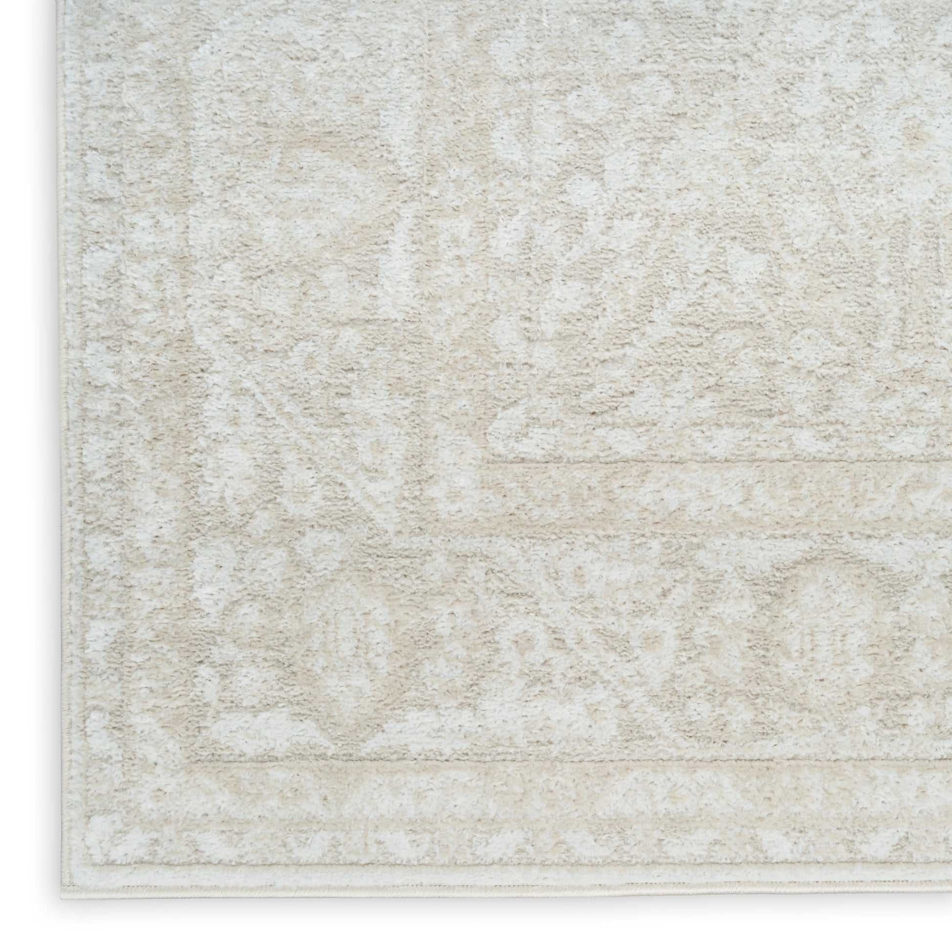 Cream beige oriental-pattern area rug with ivory motifs and light border, plush texture.