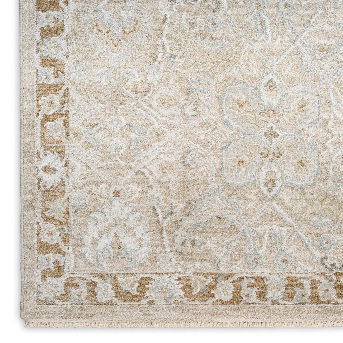 Beige oriental rug featuring cream & light blue floral motifs, bordered edge with fringe.