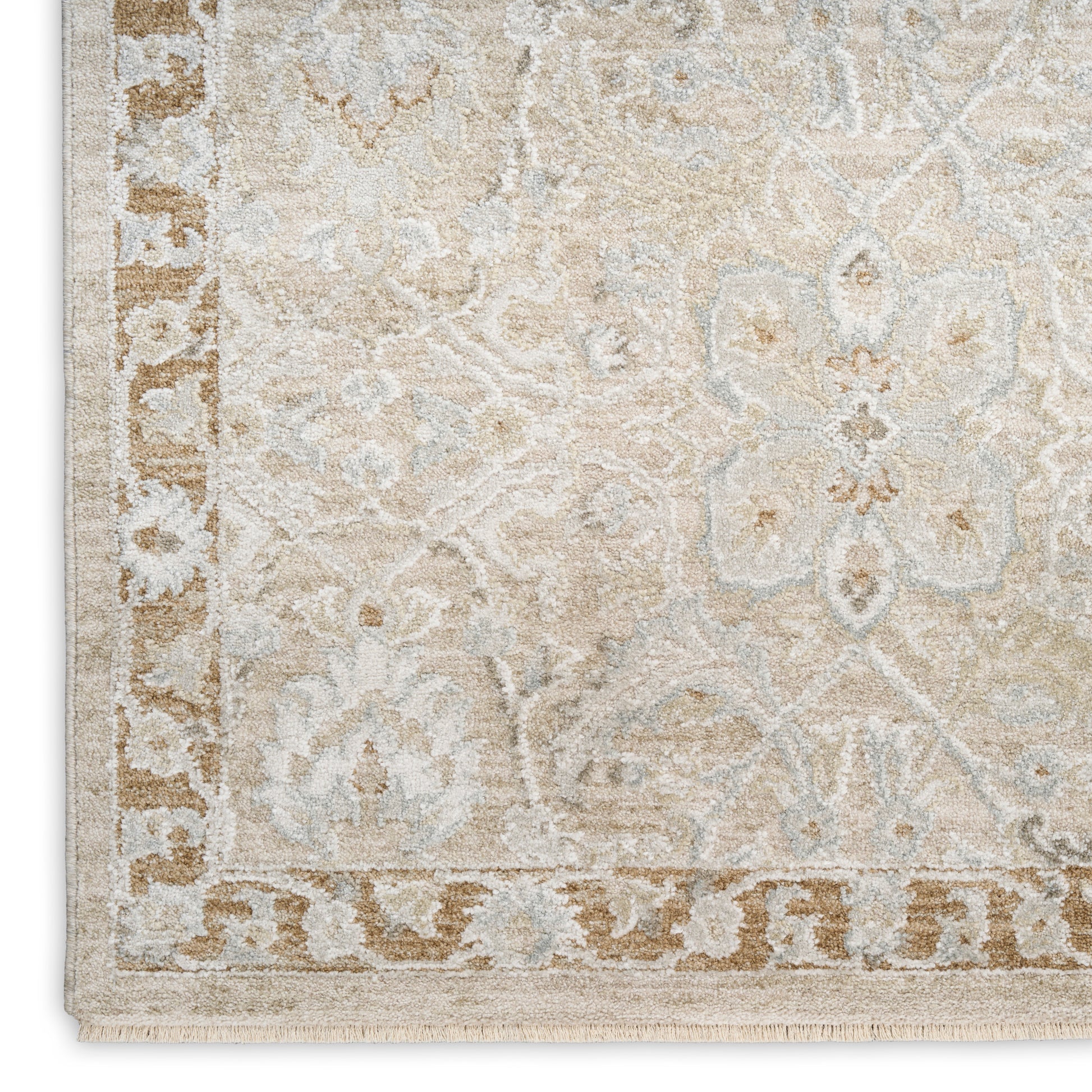 Beige oriental rug featuring cream & light blue floral motifs, bordered edge with fringe.