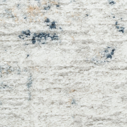 Cream shag rug with blue-gray accents and plush, fluffy pile.