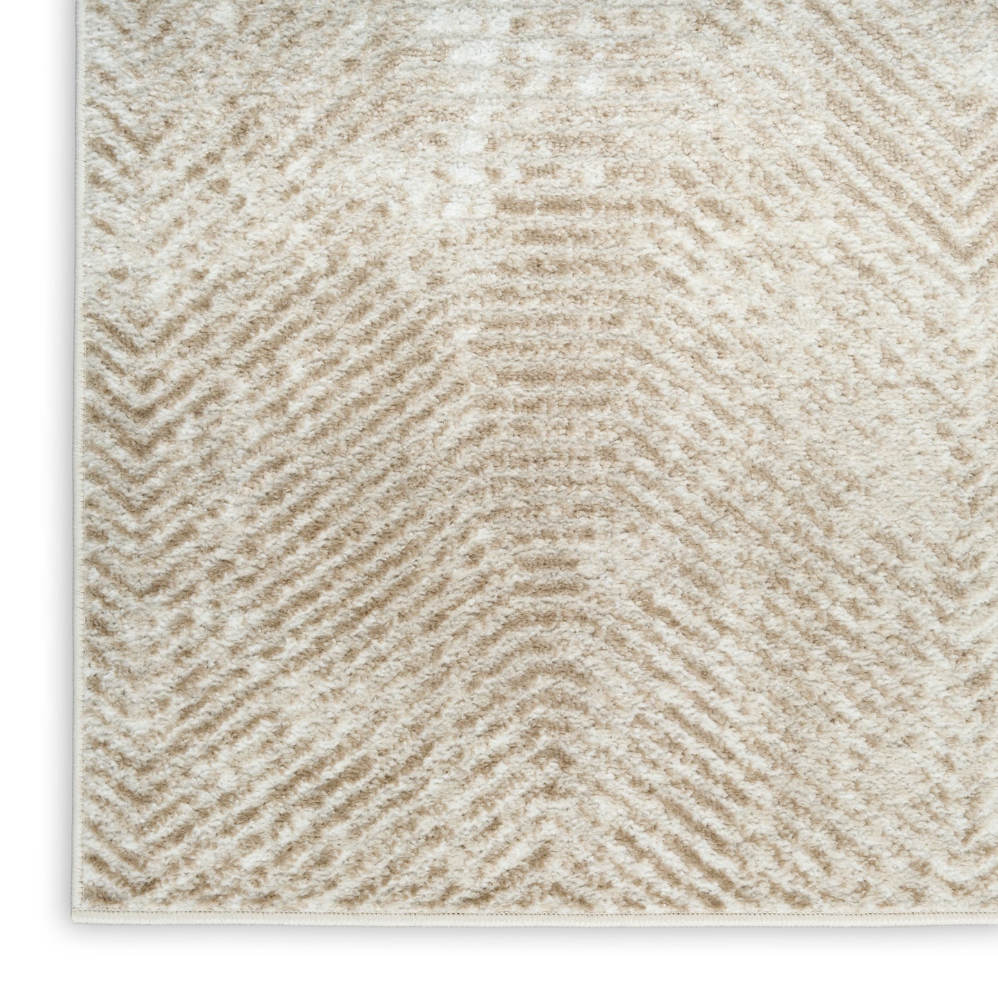 Cream textured area rug with subtle chevron pattern in soft beige fibers, plush pile.