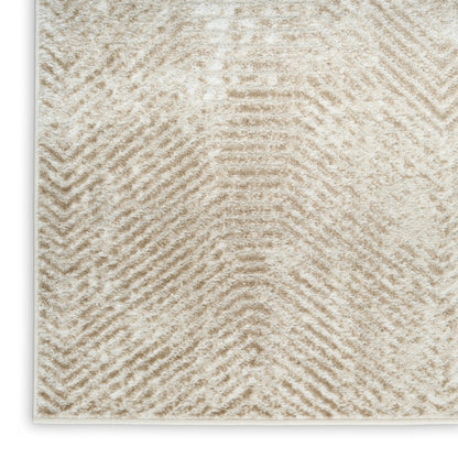 Cream textured area rug with subtle chevron pattern in soft beige fibers, plush pile.