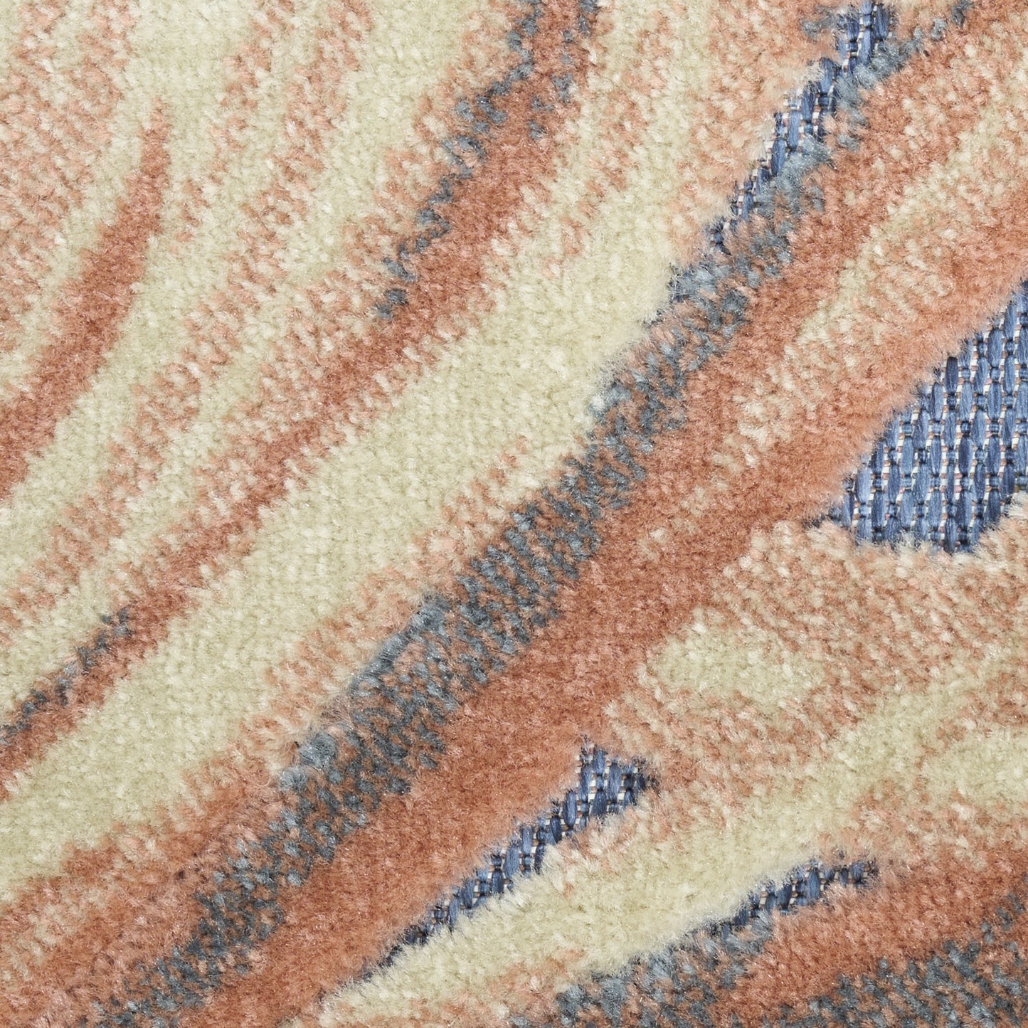 Plush shag rug with cream, beige and peach waves and blue accents; soft textured pile for living room decor.