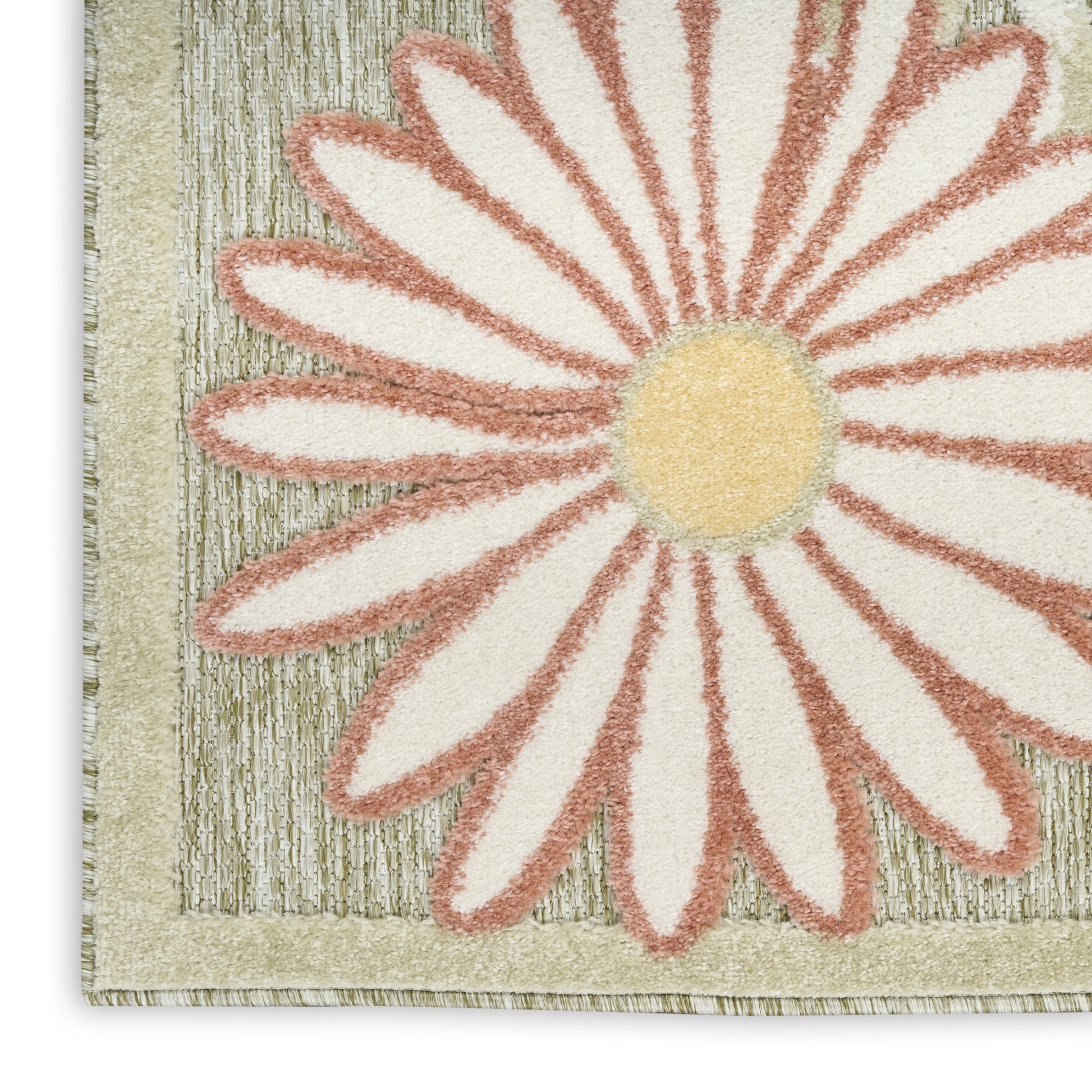 Close-up of a textured rug featuring a large cream daisy with peach-edged petals and a yellow center on a beige striped border.