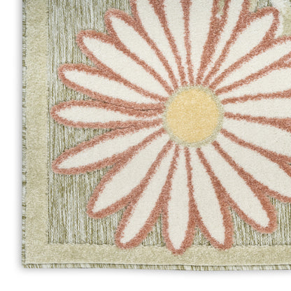 Close-up of a textured rug featuring a large cream daisy with peach-edged petals and a yellow center on a beige striped border.