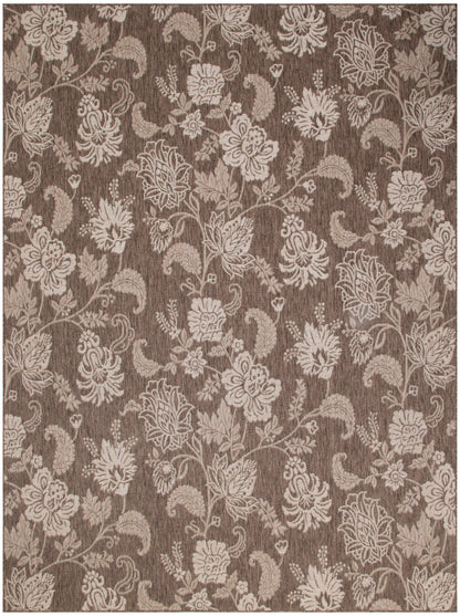 Brown damask floral rug with beige blossoms and vines on a textured background; elegant decorative floor covering.