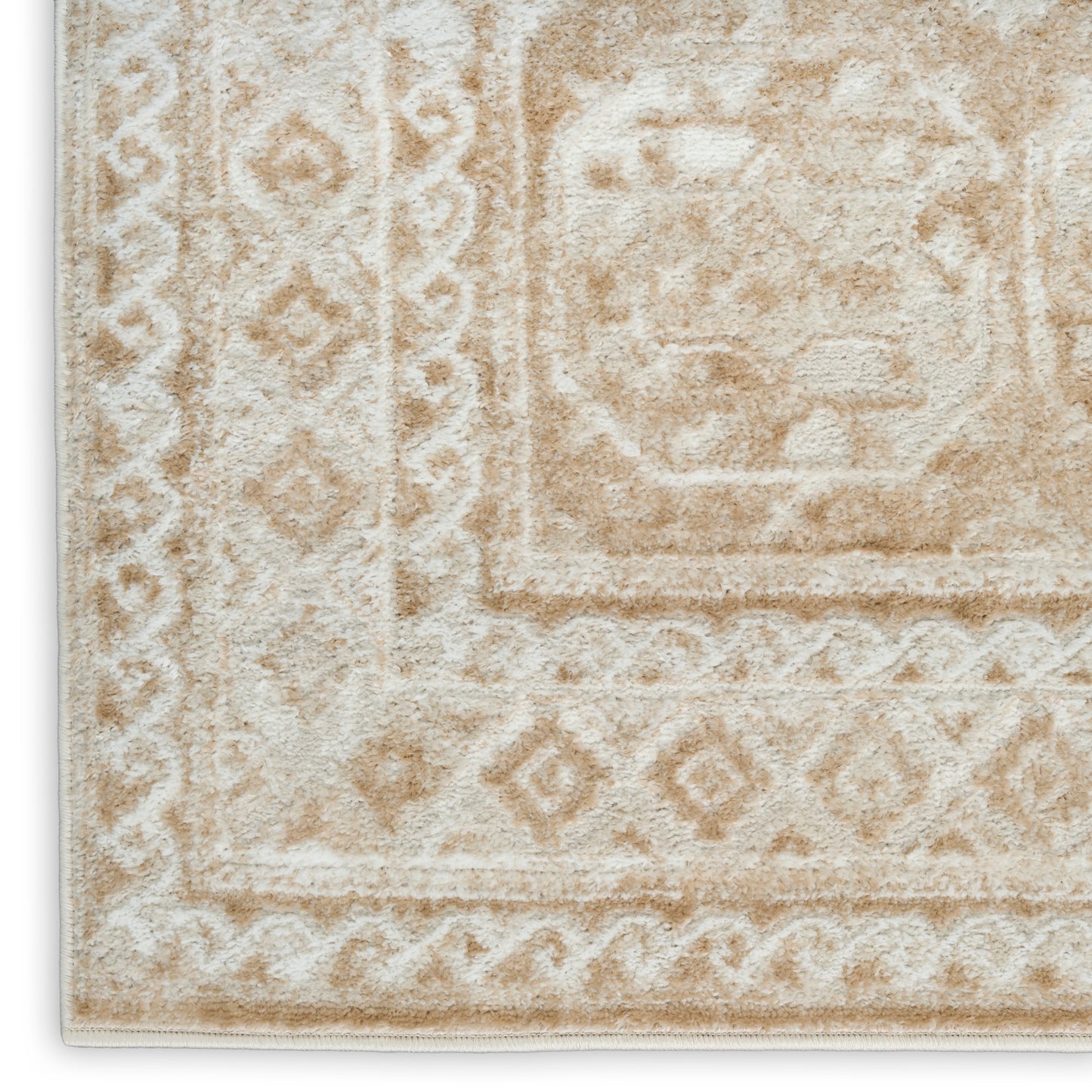 Cream-beige oriental rug with diamond border patterns and central medallion, plush textured pile.