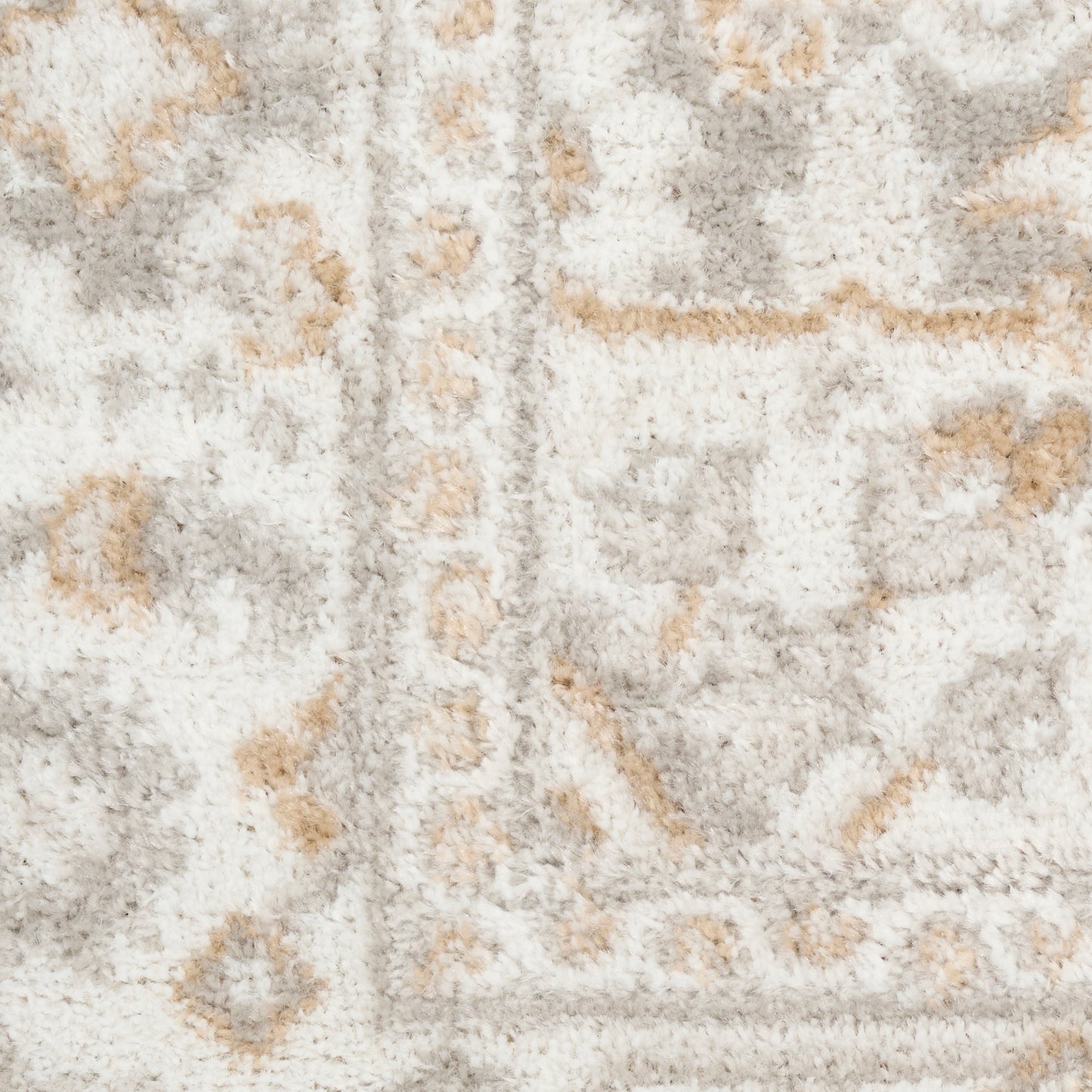 Cream shag rug featuring light gray and beige ornate pattern with a decorative border.