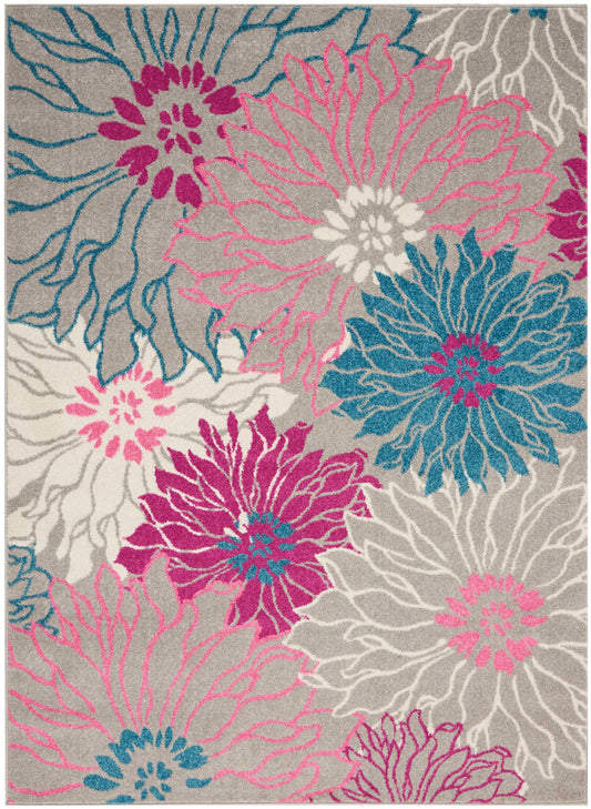 Modern floral area rug with oversized pink, magenta, teal blooms on gray backdrop; soft looped pile.