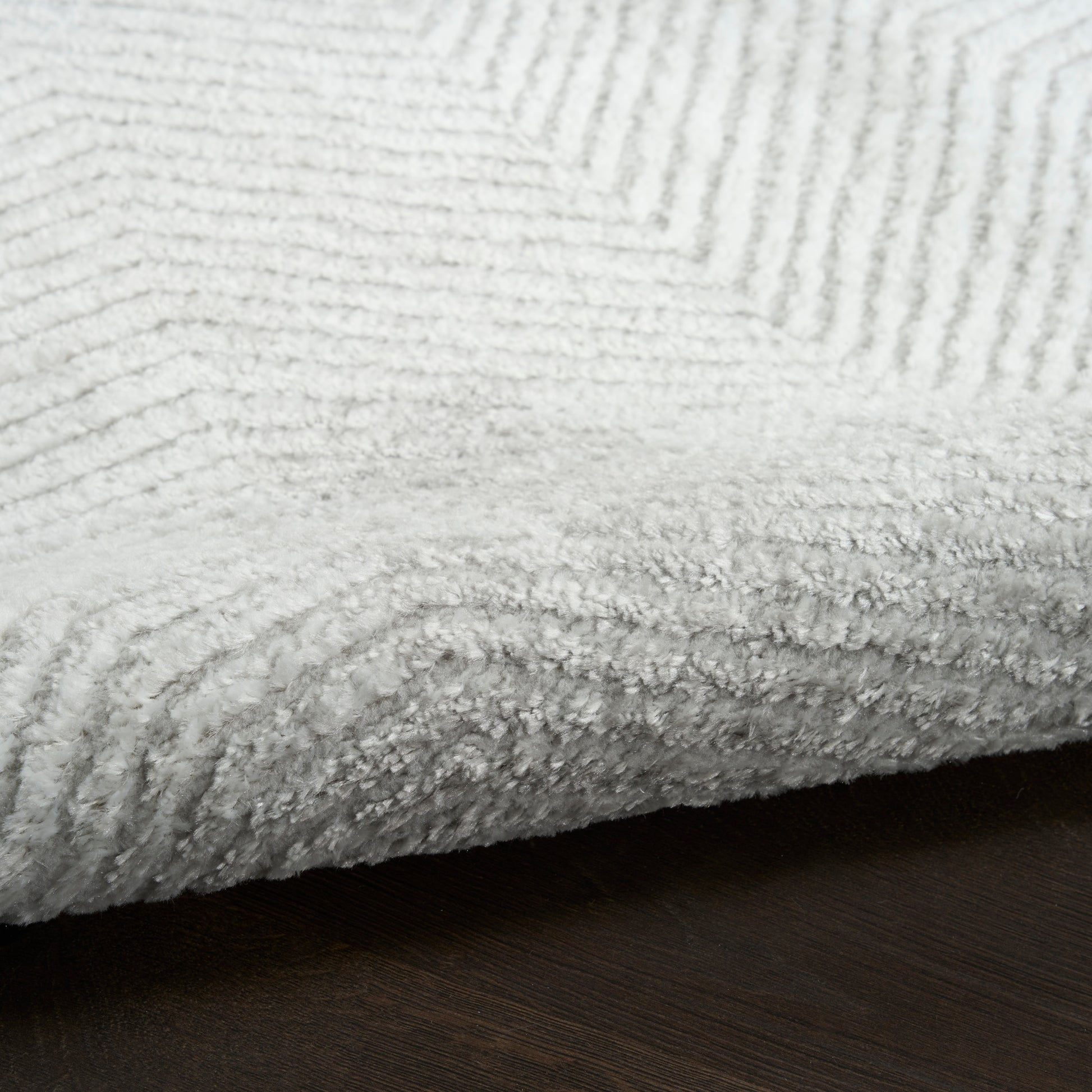Soft plush rug with ribbed texture and thick edge.