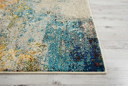 Abstract runner rug with a beige base and teal, blue, yellow and rust accents on a light wood floor.