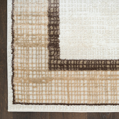 Tan & cream tufted area rug with dark brown border and geometric grid pattern, corner view on wood floor.