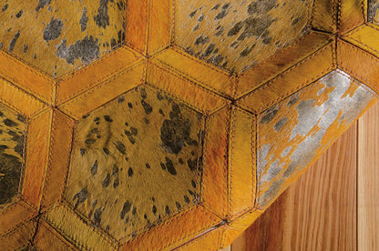 Orange leather hexagonal paneling with orange stitching and leopard print texture, against wooden floor.