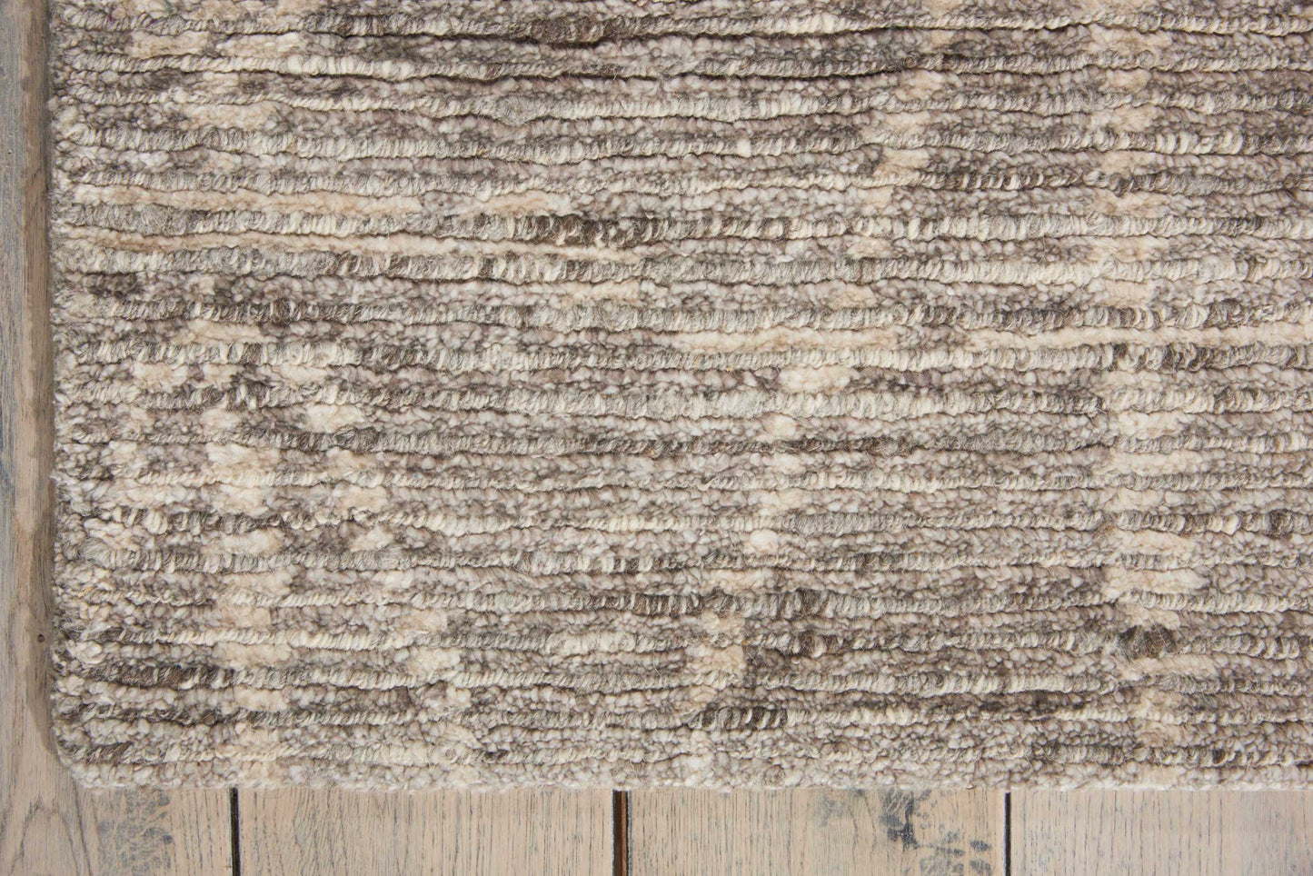 Beige shaggy area rug with soft plush pile in taupe and cream tones (6' x 8') on wooden floor.