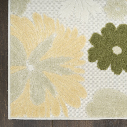 Floral area rug with yellow petals, olive-green flower, green leaves on cream background; textured pile, bound edge.