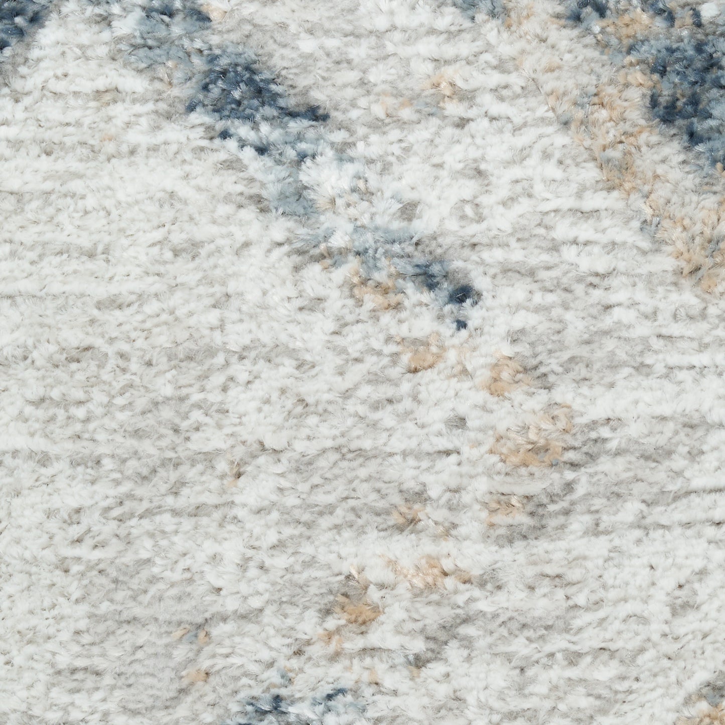 Cream shag rug with blue-gray and beige flecks; plush, fluffy pile for cozy spaces.